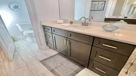 Bathroom with sink, mirror, and decoration.