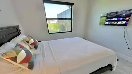 Guest room with TV and outdoor view