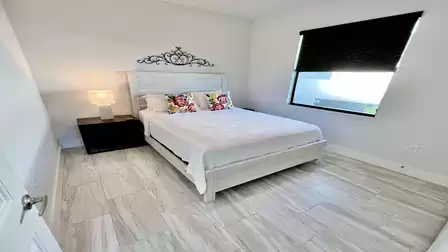Bright bedroom with white bed and wall decor