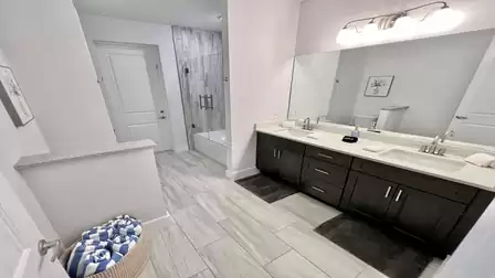 Spacious bathroom with double sink and bathtub