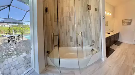 Bathroom with bathtub and view of the patio