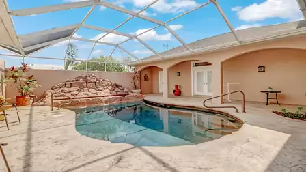 Screened pool area with natural stone waterfall