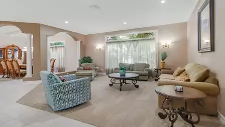 Elegant living room with classic décor and large windows.