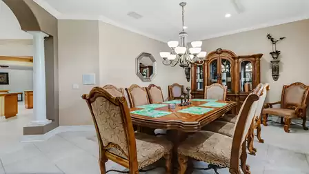 Elegant dining room with a high-quality wooden table and luxurious chairs.