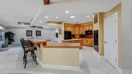 Open kitchen with a spacious countertop and elegant bar counter.