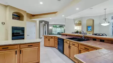 Spacious kitchen with an island, double oven, and modern design.