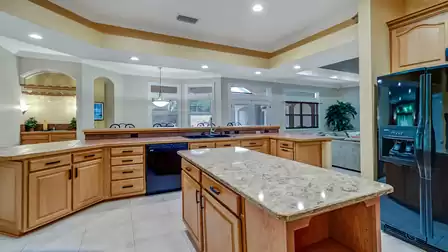 Modern kitchen with a granite island and high-quality wooden cabinets.