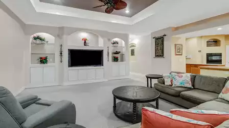 Bright living room with elegant ceiling design and large windows.