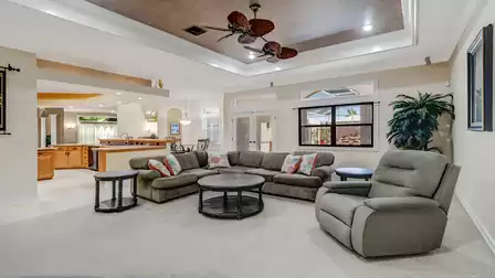Comfortable seating area with plush upholstered furniture and tropical accents.