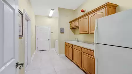 The spacious laundry room is equipped with an additional sink and plenty of storage space.