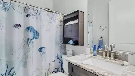 The bedroom has a beautiful, maritime bathroom