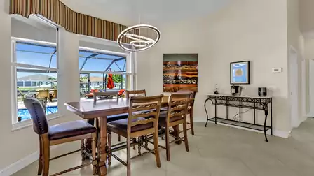 Dining area with views over the pool and the canal