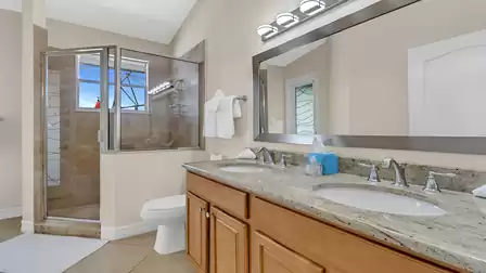 Bright bathroom with his and her sink and walk-in shower