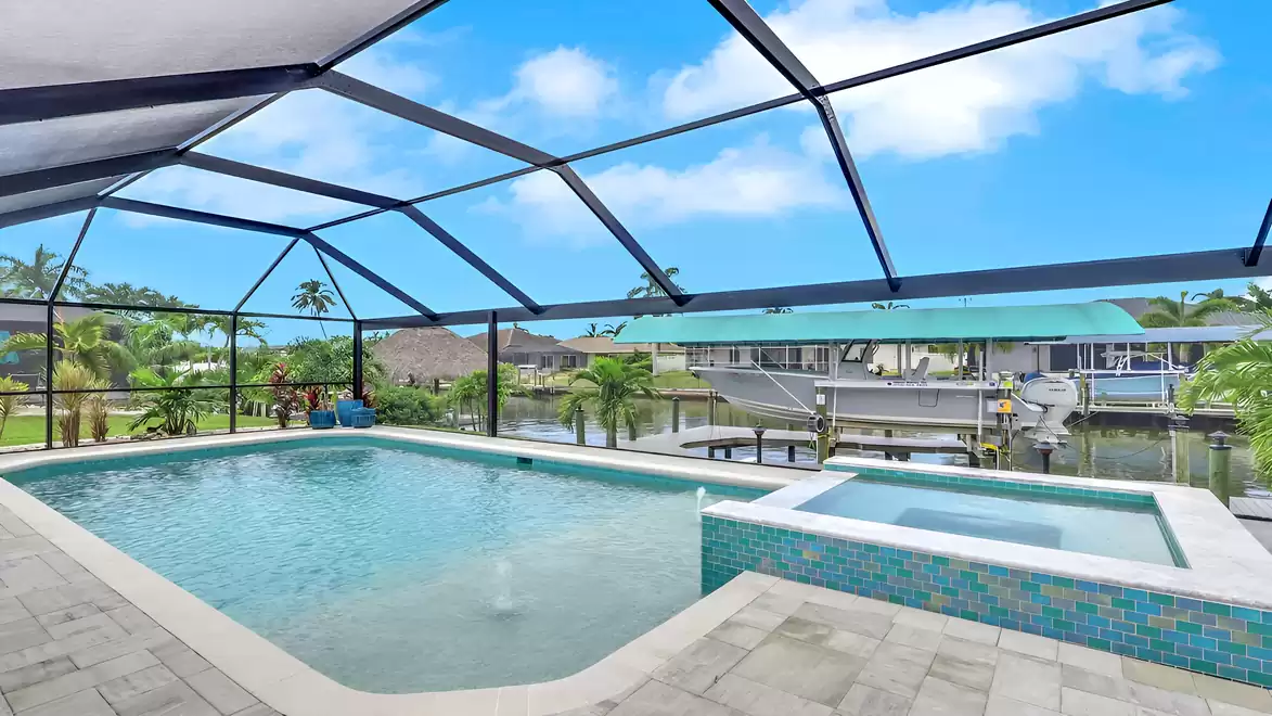 Pool and spa at Villa Kamala in Cape Coral with canal view and boat lift.