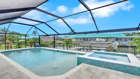 Pool and spa at Villa Kamala in Cape Coral with canal view and boat lift.