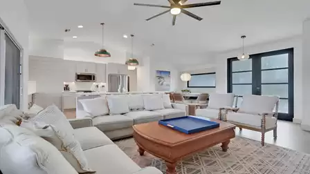 Open-plan living area with comfortable sofas, a modern kitchen, and dining space.