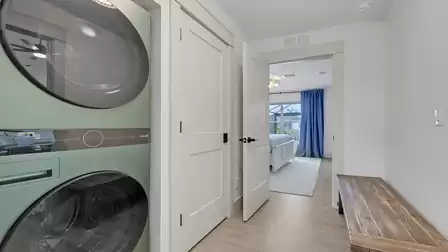 Laundry room with washer and dryer and direct access to the bedroom.