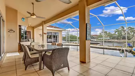 The covered outdoor terrace offers space for six people at a modern dining table