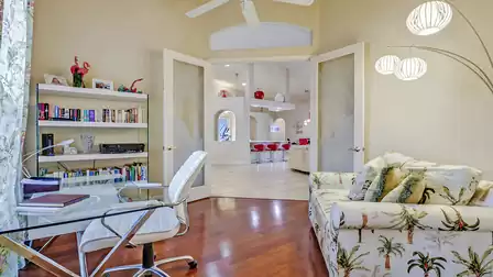 The large double doors invite you into a study full of character