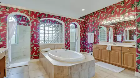 The freestanding bathtub is surrounded by colorful
