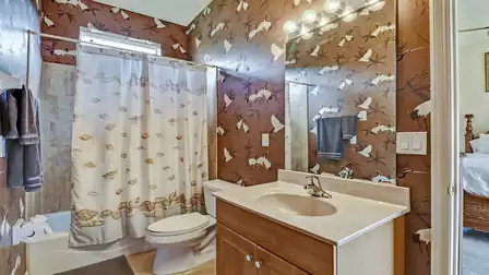 An elegant bathroom decorated with a unique crane wallpaper