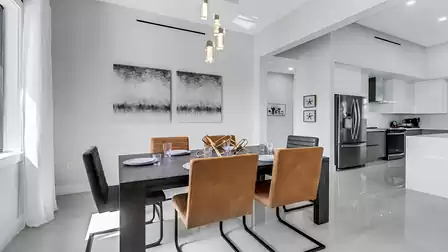 Open-plan dining area seamlessly connected to the modern kitchen