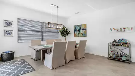 The dining area has an elegant dining table that also seats six people