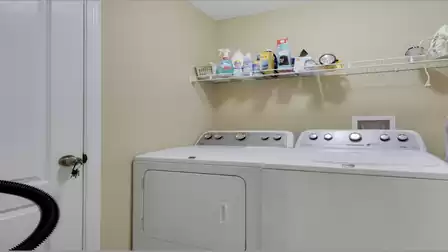 Laundry room with a washer, dryer, and practical storage space.