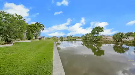 Well-maintained garden with a waterfront edge and views of the peaceful canal.