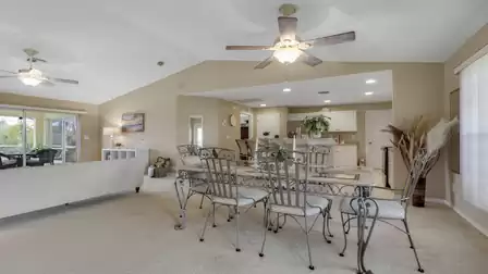 Open living and dining area with a kitchen island and direct access to the patio.