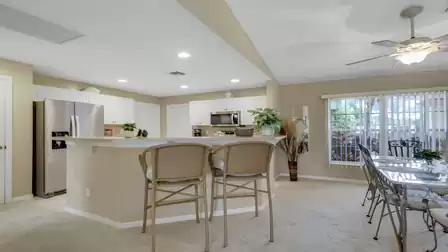 Open kitchen with a breakfast bar and adjoining dining area.