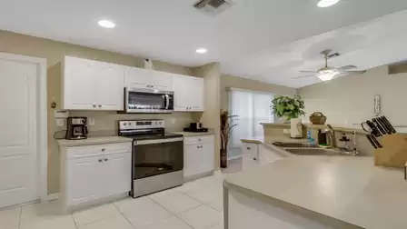 Bright open kitchen with modern appliances and ample counter space.