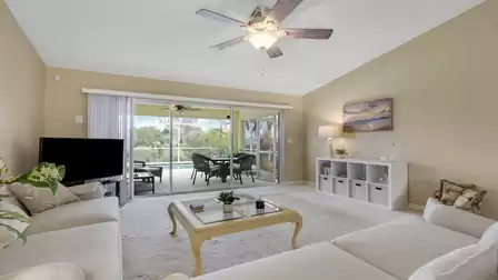Cozy living area with large sofas and direct access to the covered pool patio.
