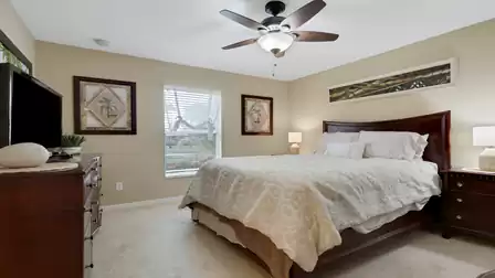 Bright bedroom with a large double bed and tasteful furnishings.