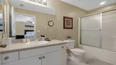 Bright bathroom with a vanity, bathtub, and integrated shower.