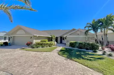 Beautiful driveway to the villa with tropical garden at the entrance