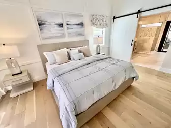 Bedroom and bathroom separated by a beautiful country-style sliding door