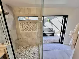 The bathroom has direct access to the pool and terrace
