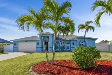 Driveway and entrance to Villa Orange Cove, lined with palm trees