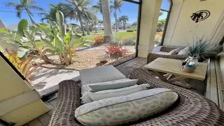 A cozy seating area that offers a breathtaking view of the lush tropical landscape