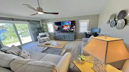 An inviting living area that creates a seamless connection between indoor and outdoor areas through high doors to the terrace