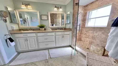 An elegant adjoining bathroom equipped with a spacious walk-in shower