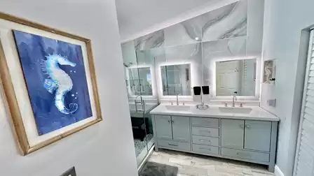 A stylish bathroom equipped with numerous mirrors and two washbasins