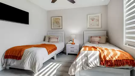 The room is furnished with two comfortable single beds