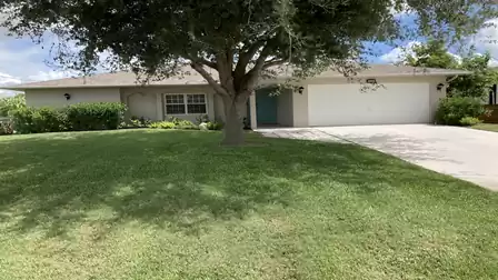 This picturesque driveway is lined with manicured lawns