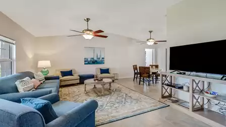 The spacious living room impresses with numerous comfortable seating options