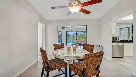 At the heart of the room is an elegant dining table that seats four people