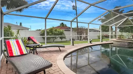 Two sun loungers with colorful towels by the pool - relaxing vacation vibes under the Florida sky.