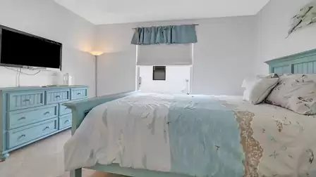 Cozy bedroom with turquoise furniture set and beach-themed bedding.