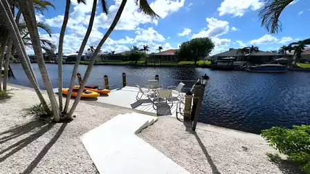 Private dock with chairs and kayaks right on the canal - perfect for water sports lovers